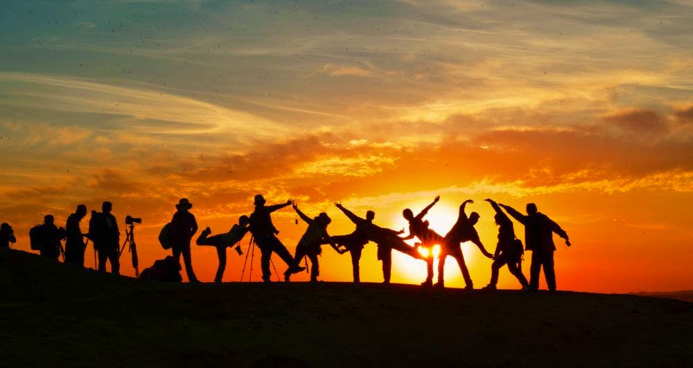 silhouettes at sunset in the sahara